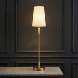 Petra Buffet Lamp 27, Modern Brass styled in a Modern Living Room with marble countertop and dark paneled walls