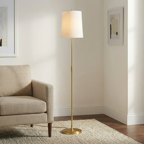 Petra Floor Lamp 65", Modern Brass linear Floor Lamp in a Transitional Living Room with a beige linen armchair.