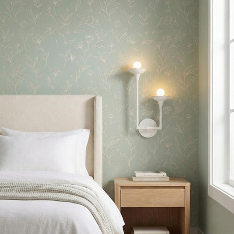 Serene Double Wall Sconce Matte White scalloped wall sconce in a Transitional Bedroom with a beige headboard & botanical wallpaper.