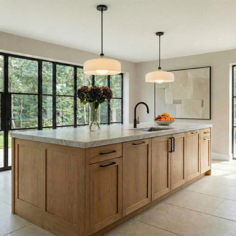 Alder Pendant 15", Black with Milk Glass globe pendant in a Modern Farmhouse Kitchen with a white marble island and oak cabinets.