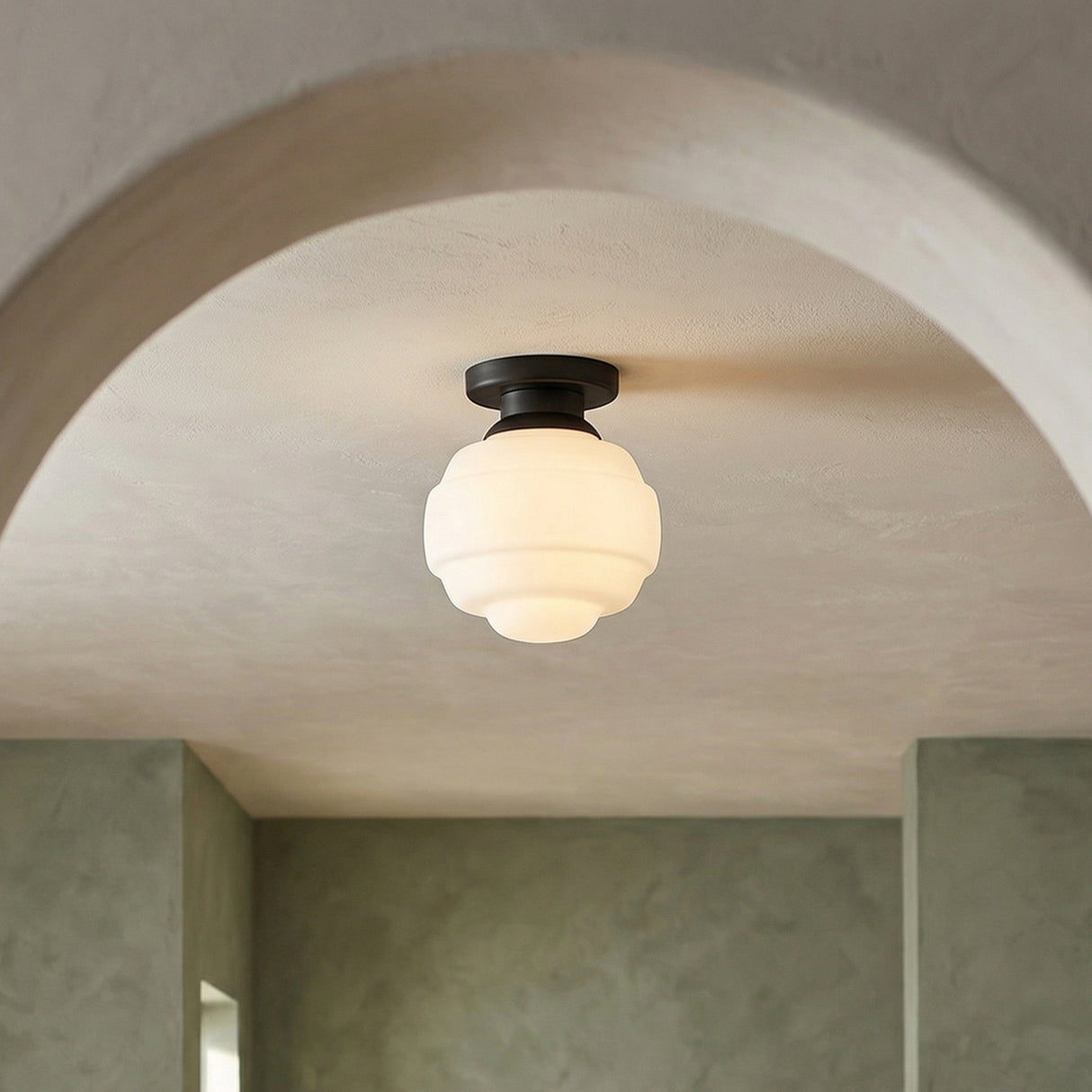 Irving Small Flush Mount 9", Black geometric flush mount in a Modern Entryway with a stucco archway and muted green walls.