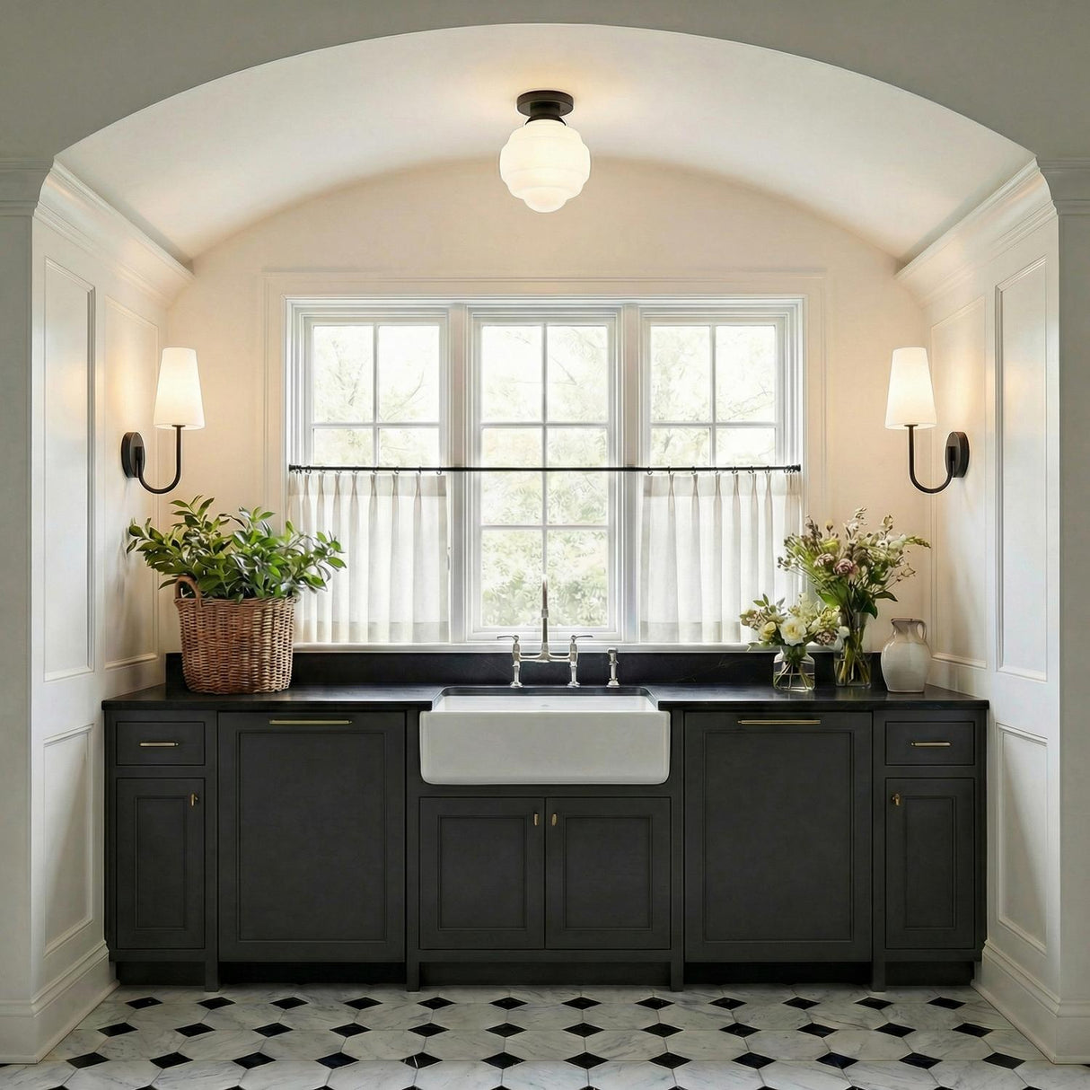 A transitional kitchen features an Irving Medium Flush Mount 12", Black with frosted glass along an arched ceiling over a farmhouse sink and charcoal cabinets.