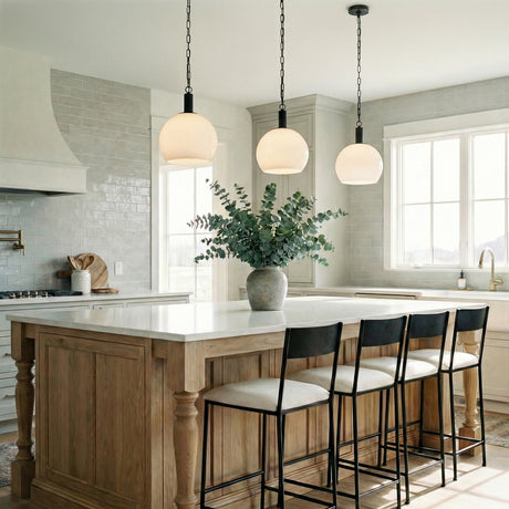 Opal Globe Pendant, Black globe pendant in a Modern Farmhouse Kitchen with a white marble island and wooden cabinetry.