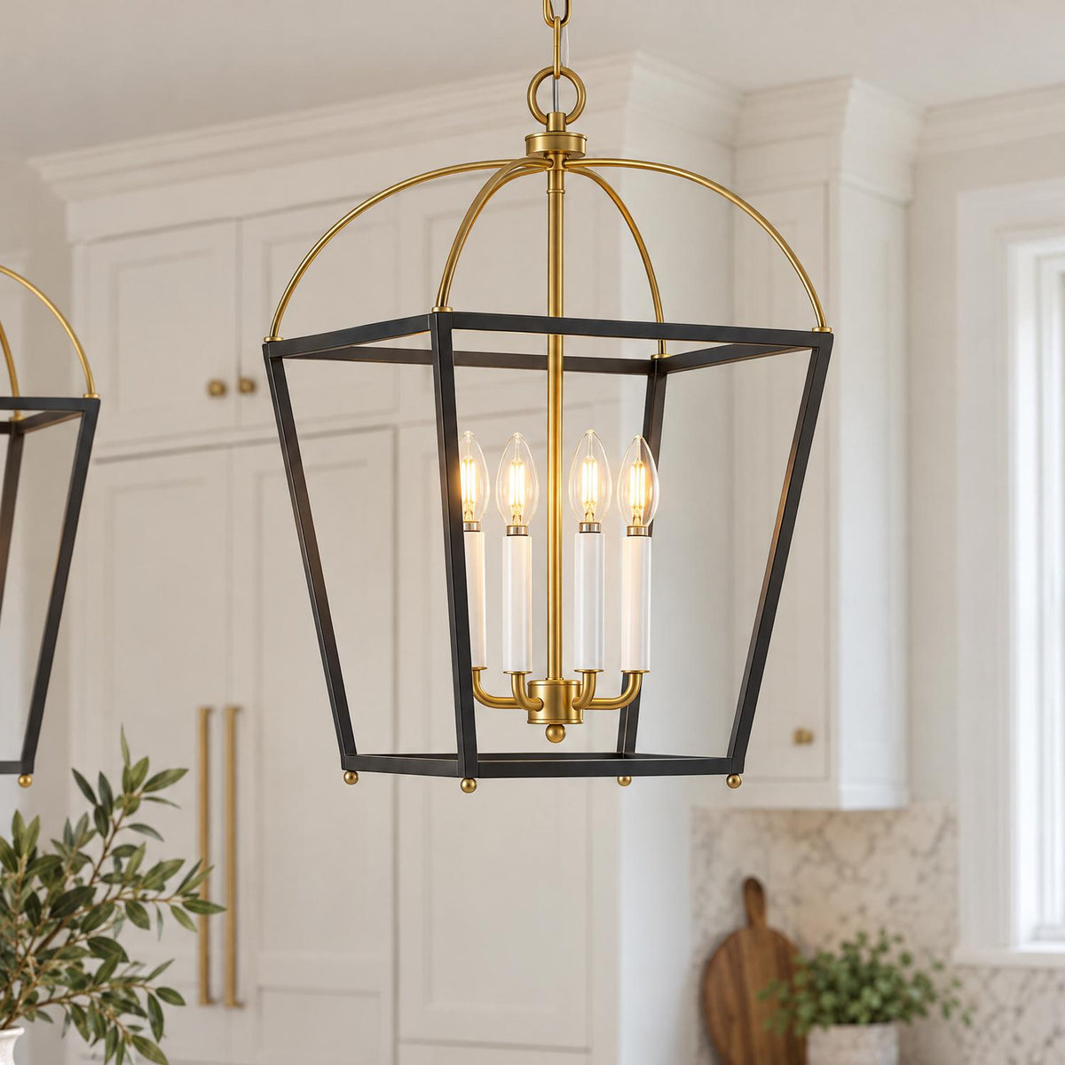 A transitional kitchen features a Langford Large Lantern Pendant in black and satin brass over an island with white cabinetry and a marble backsplash.