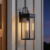 Monterey Outdoor Wall Light, Medium 18" Black geometric Outdoor Wall in a Modern Farmhouse Outdoor with white siding and wood door.