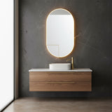 Chadwick Large LED Oval Mirror 24" x 42", Brushed Brass - A modern bathroom with a floating vanity and an illuminated tall oval mirror.