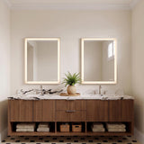 A modern bathroom featuring two Demott Large LED Rectangular 28" x 36" mirrors in brushed nickel mounted above a fluted wood vanity with marble countertops.