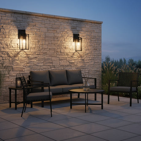 Peyton Outdoor Wall Light, Small 15" Textured Black - Two black outdoor lights flank a stone wall and patio furniture.