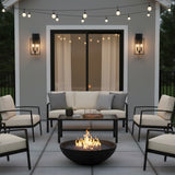 Peyton Outdoor Wall Light, Medium 18" Textured Black - An outdoor patio area with a fire pit, sofa, chairs, and wall sconces.