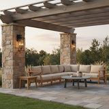 Peyton Outdoor Wall Light, Large 21" Textured Black - Two black lanterns flanking stone pillars under a wooden pergola with an outdoor sectional sofa.