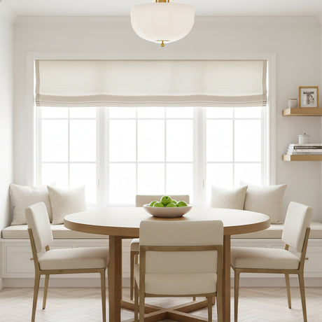 Mayfair Flush Mount 13", Aged Brass - A flush mount light fixture above a dining table in a bright, neutral-toned room.