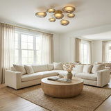 Gaia LED Flush Mount 41", Aged Brass geometric flush mount in a Transitional Living Room with a creamy sectional sofa and round wood coffee table.