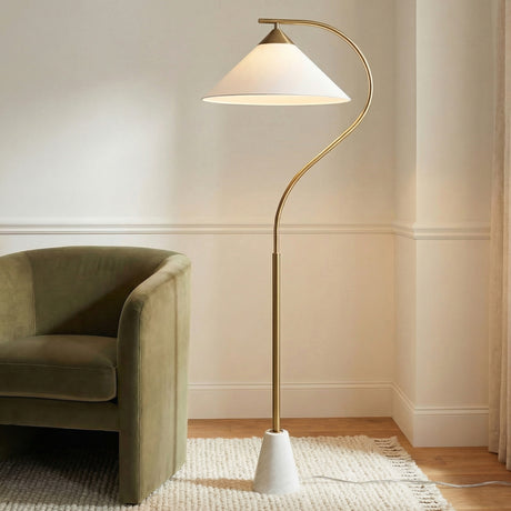 Seraphina Floor Lamp, Aged Brass geometric Floor Lamp in a Transitional Living Room with a green velvet armchair and textured rug.