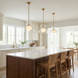 Rhett Pendant 12", Aged Brass geometric Pendant in a Transitional Kitchen with a dark wood island & woven cane bar stools.