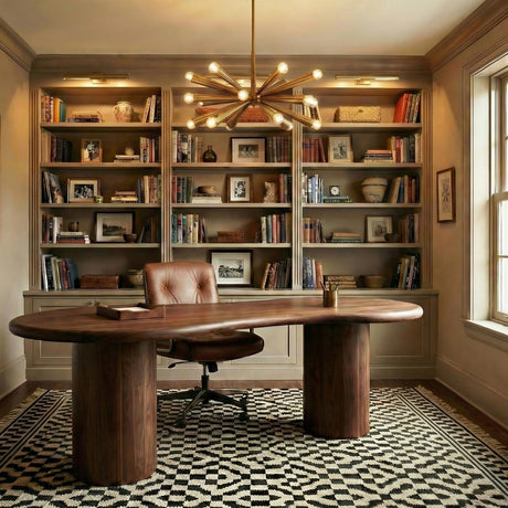 Camellia Medium Chandelier 30", Patina Brass geometric Chandelier in a Transitional Office with a curved walnut desk and leather chair, in the background is the Ethan Picture Light above the bookshelves.
