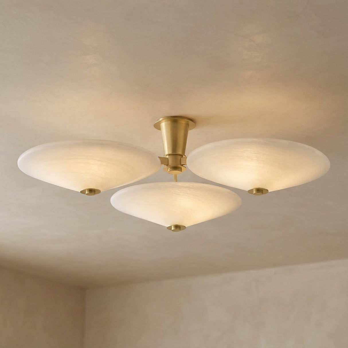 Imogen Vintage Brass and Opal Glass geometric flush mount in a Contemporary Living Room with neutral textured walls.