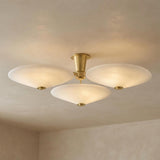 Imogen Vintage Brass and Opal Glass geometric flush mount in a Contemporary Living Room with neutral textured walls.