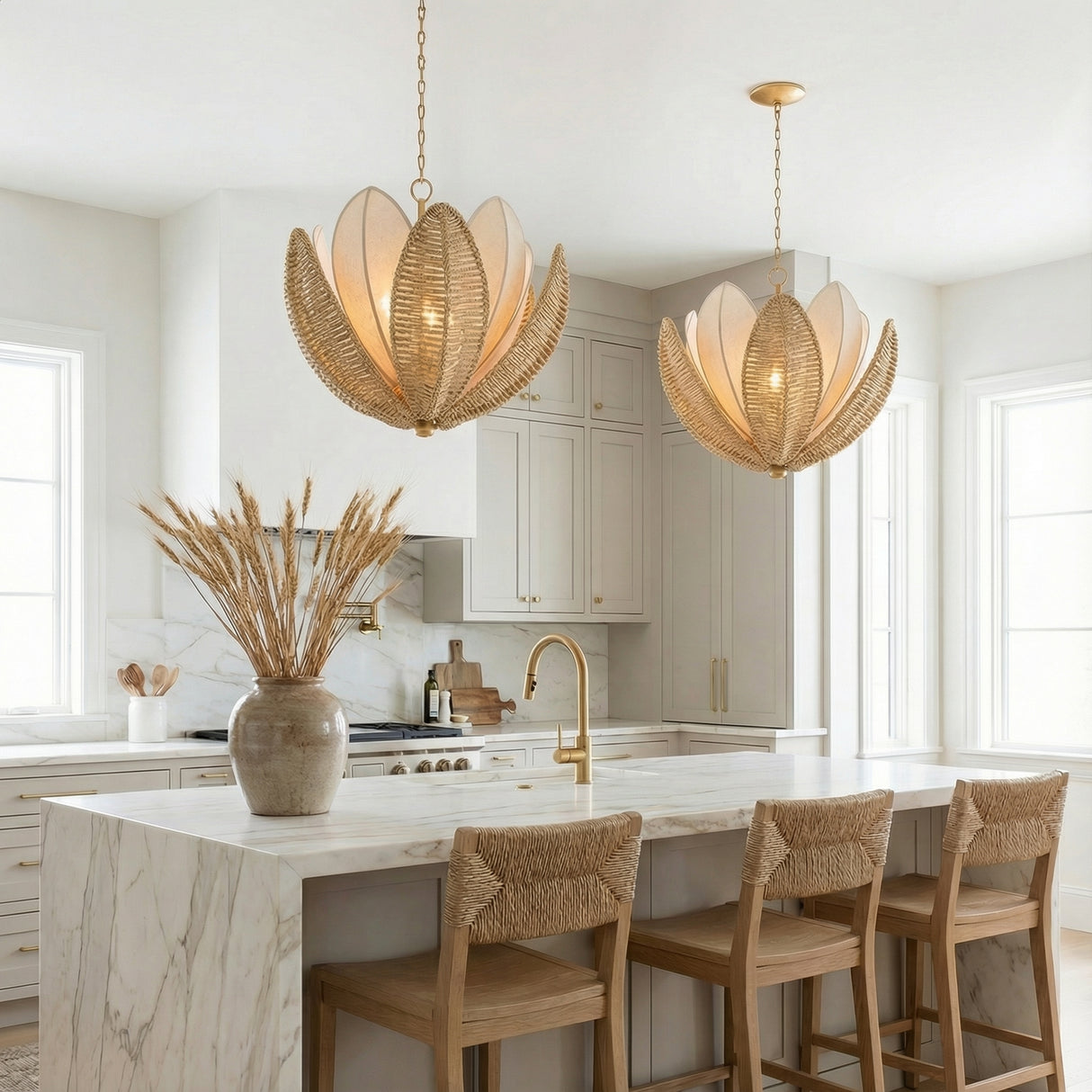 Natural Woven and Gold leaf design Chandelier in a Coastal Kitchen with a white marble island and woven bar stools.