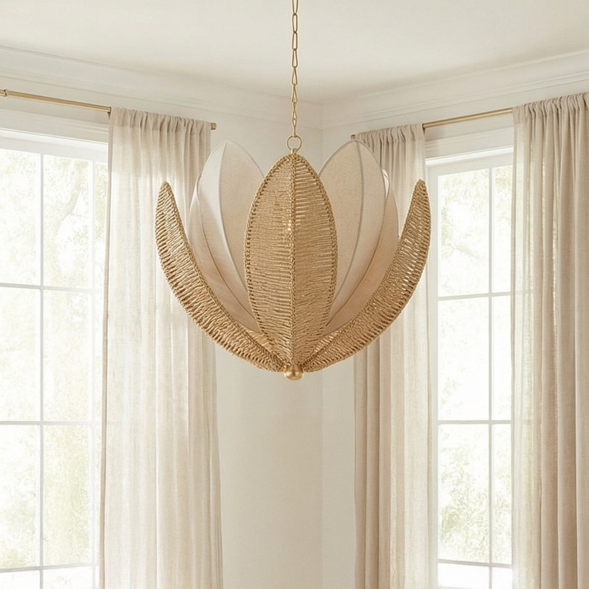 Natural Woven and Gold woven leaf design Chandelier in a Coastal Living Room with large windows and sheer curtains.