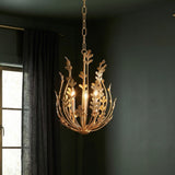 Annelise Chandelier 14", Gold leaf design Chandelier in a Transitional Living Room with deep green walls and dark grey curtains.