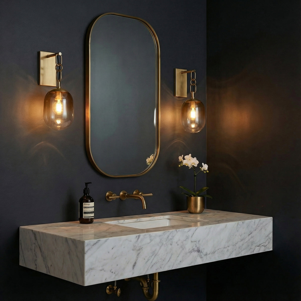 Blythe Wall Sconce 18", Patina Brass and Topaz Gradient Glass globe wall sconce in a Contemporary Bathroom with a marble vanity.