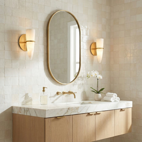Vintage Brass and Alabaster linear Wall Sconce in a Transitional Bathroom with a white marble vanity and light wood cabinet.