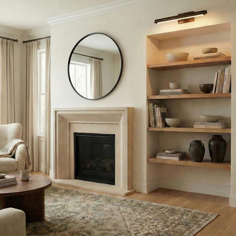 Quentin Large LED Picture Light 24", Bronze linear wall sconce in a Transitional Living Room with built-in wooden shelves.