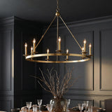 William 9 Light Ring Chandelier 46", Aged Brass geometric Chandelier in a Transitional Dining Room with dark paneled walls.