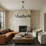 William 9 Light Ring Chandelier 46", Matte Black geometric chandelier in a Transitional Living Room with a brown leather sectional and rustic wood coffee table.