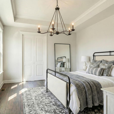 Tamsin 6 Light Chandelier 40, Forged Iron geometric Chandelier in a Modern Farmhouse Bedroom with an iron bed and patterned rug.