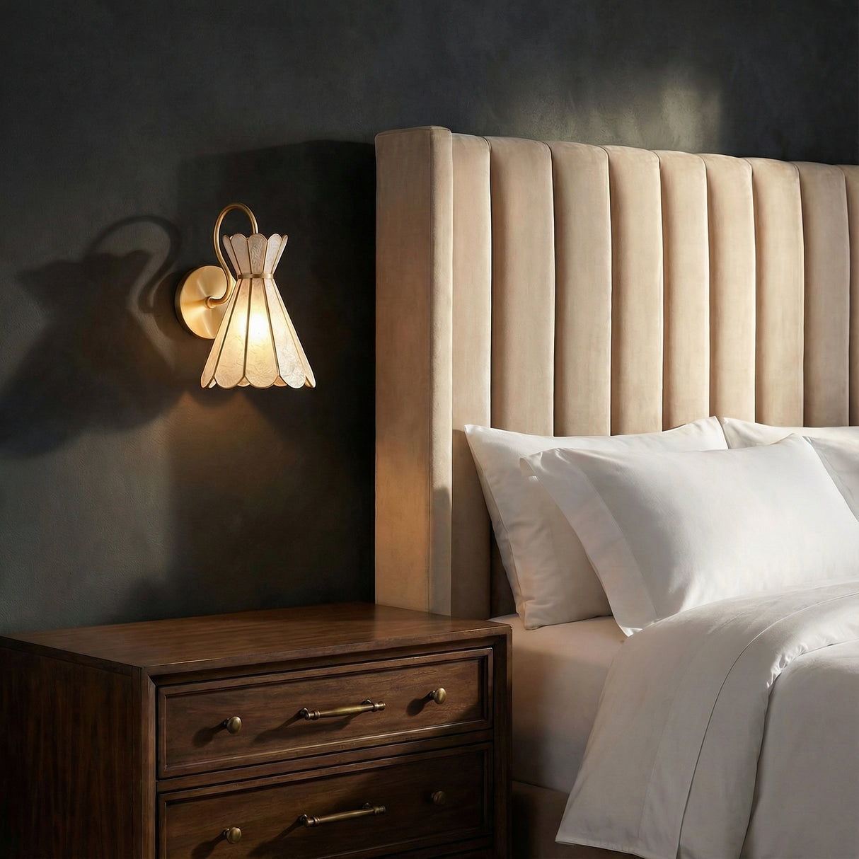 Winifred Wall Sconce 12", Aged Brass scalloped wall sconce in a Transitional Bedroom with a channel-tufted headboard.