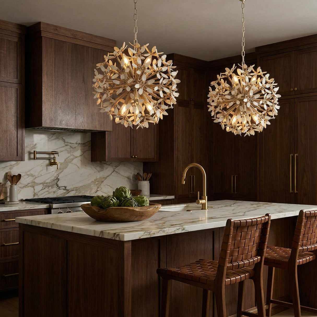 Distressed gold off-white leaf design Chandelier in a Transitional Kitchen with a marble island & woven leather stools.