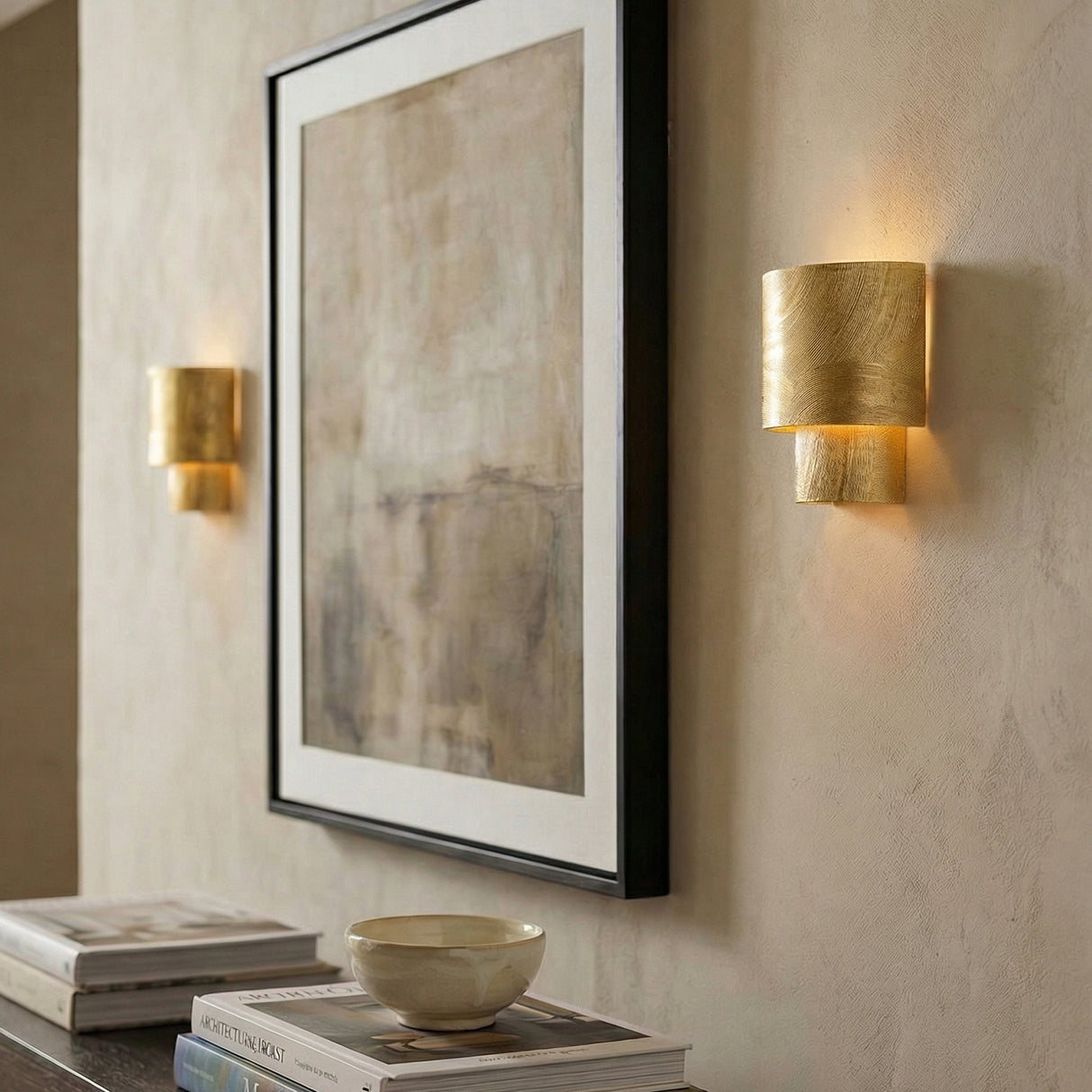 Barron Wall Sconce 9", Textured Gold geometric wall sconce in a Contemporary Living Room with framed artwork and books.