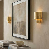 Barron Wall Sconce 9", Textured Gold geometric wall sconce in a Contemporary Living Room with framed artwork and books.