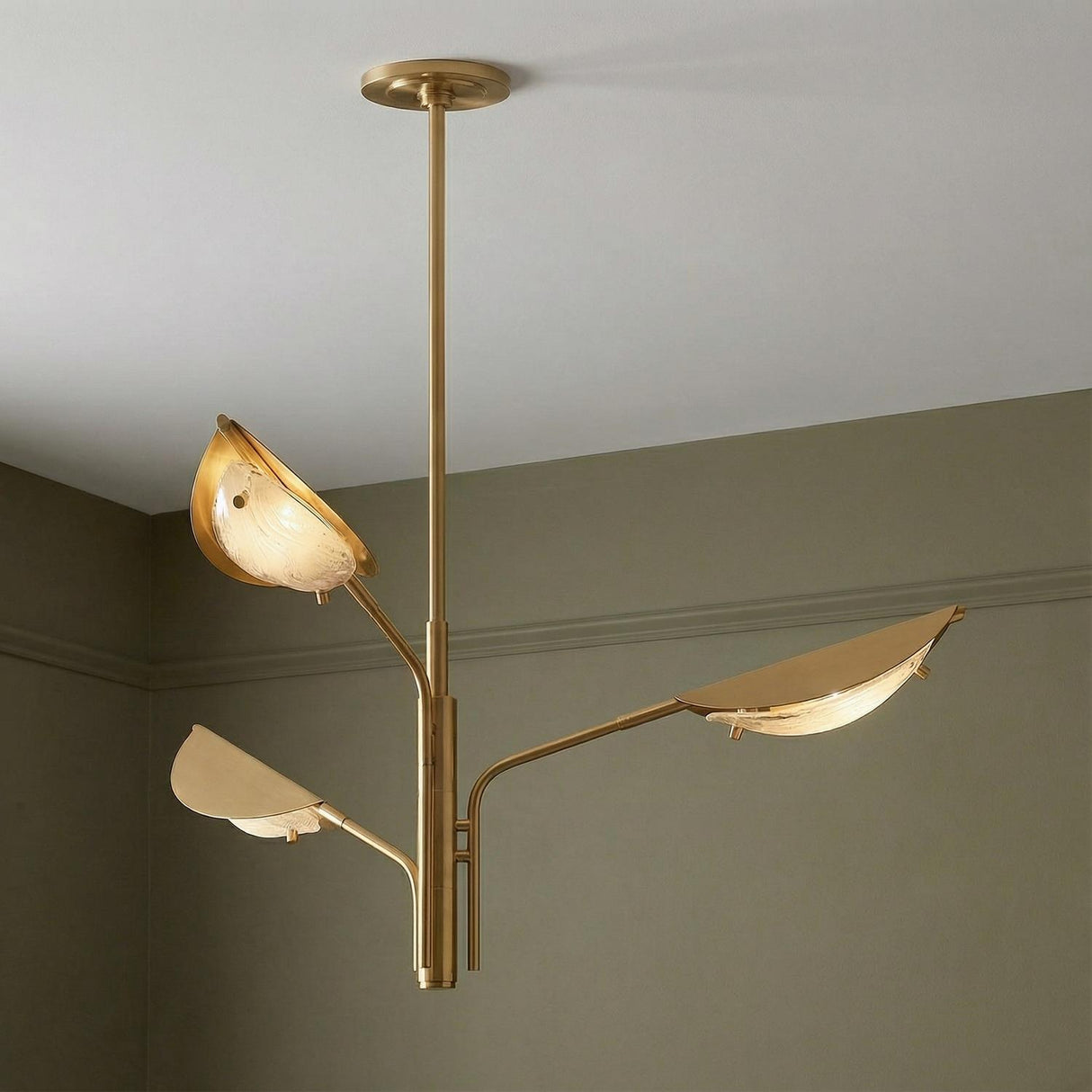 Gabrielle 3 Light Chandelier, Aged Brass with Art Glass leaf design Chandelier in a Contemporary Dining Room with sage green walls.