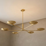 Phoebe 6 Light LED Chandelier 56", Aged Brass geometric Chandelier in a Modern Living Room with neutral textured walls.