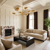 A transitional living room with the Reverie 8 Light LED Chandelier 45", Gold Leaf centered under a coffered ceiling, featuring a purple veined marble fireplace.