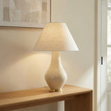 Lucille Table Lamp, Glossy Cream woven Table Lamp in a Transitional Entryway with a natural wood console and abstract art.