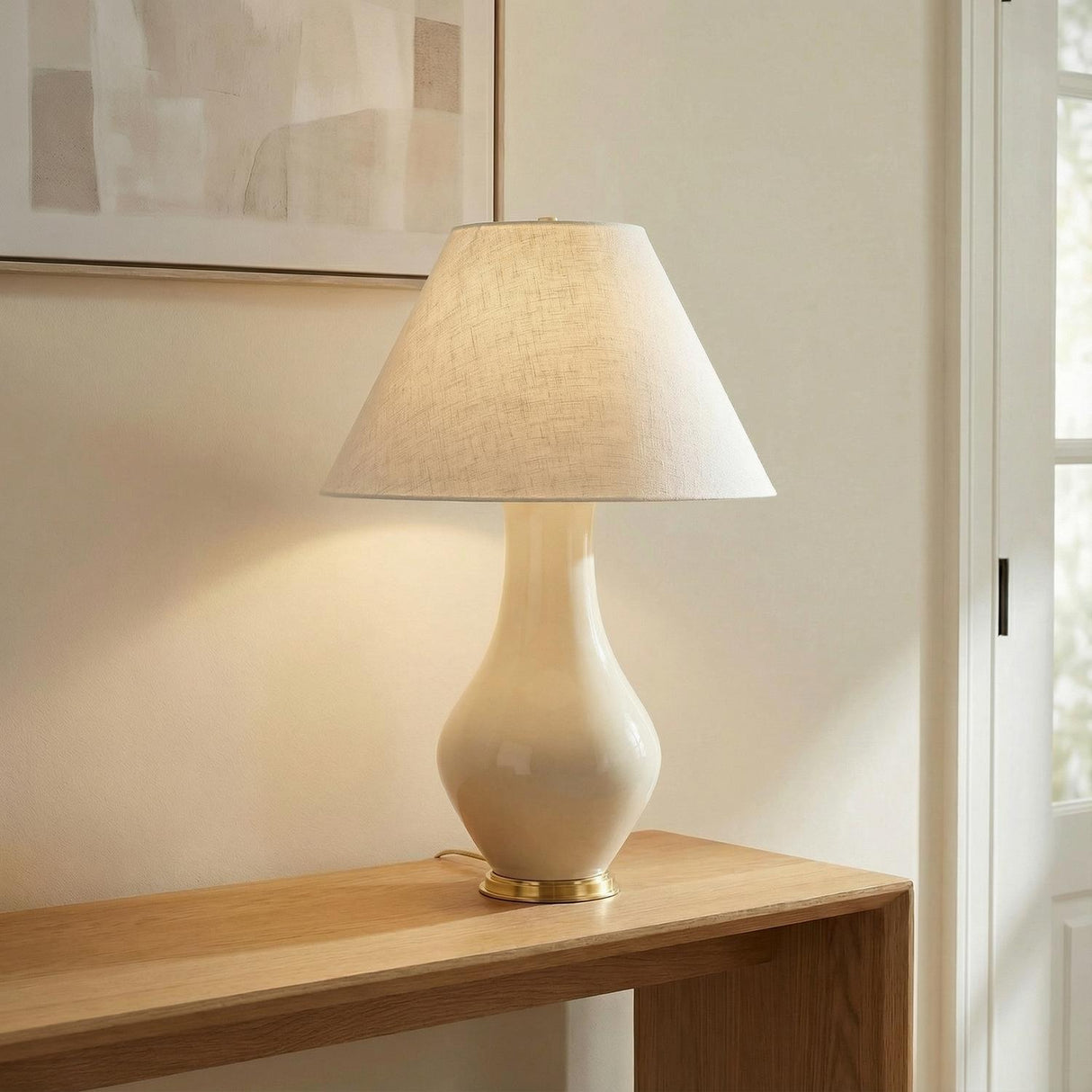 Lucille Table Lamp, Glossy Cream woven Table Lamp in a Transitional Entryway with a natural wood console and abstract art.