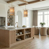Gold and woven cylinder pendant in a Transitional Kitchen with a white marble island and arched alcoves.