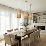 Valerie Pendant 20", Gold Leaf and Natural Rope Gold woven pendant in a Transitional Dining Room with a dark wood table.