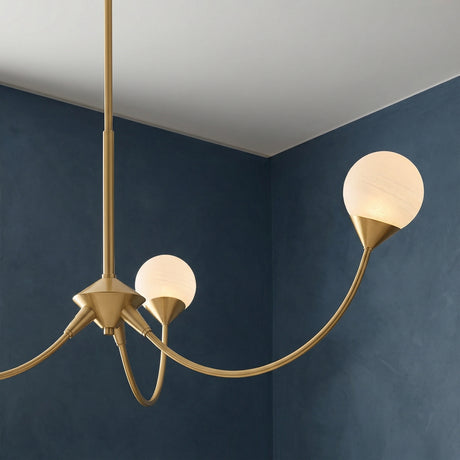 Isabella 3 Light Chandelier 36", Aged Brass with Art Glass globe Chandelier in a Modern Living Room with a deep blue accent wall.