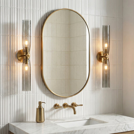 Ernest 2 Light Wall Sconce 24", Aged Brass and Smoke Glass linear Wall Sconce in a Contemporary Bathroom with a marble vanity.