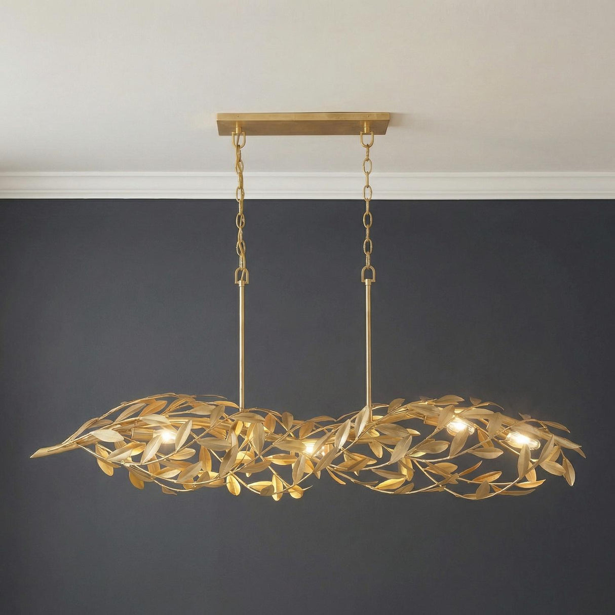 Artemis Linear Chandelier 48", Antique Gold leaf design Chandelier in a Transitional Dining Room with a dark charcoal wall.