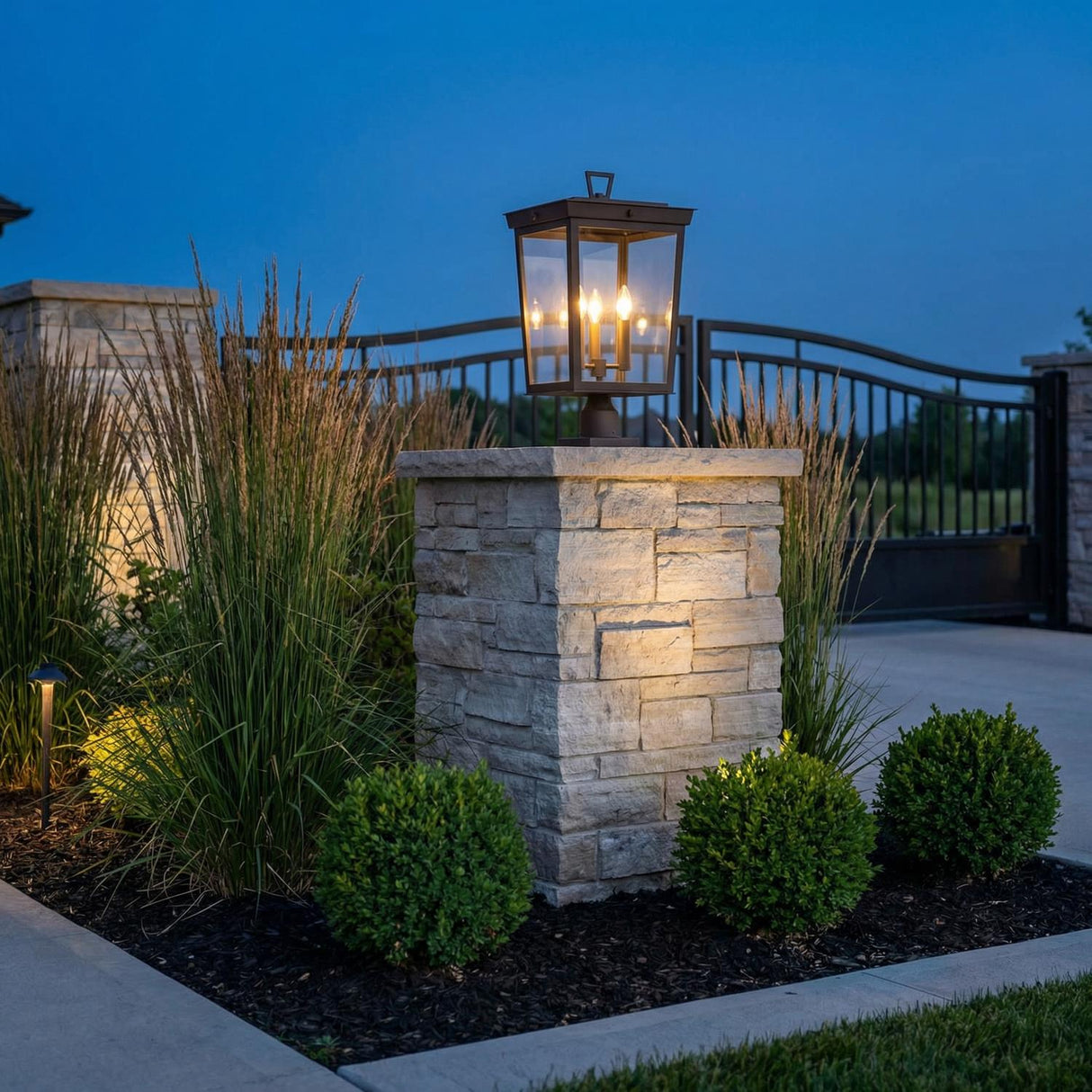 Radcliffe Outdoor Post Light, Old Bronze geometric Outdoor Post in a Craftsman Outdoor with a stone pillar and tall grasses.