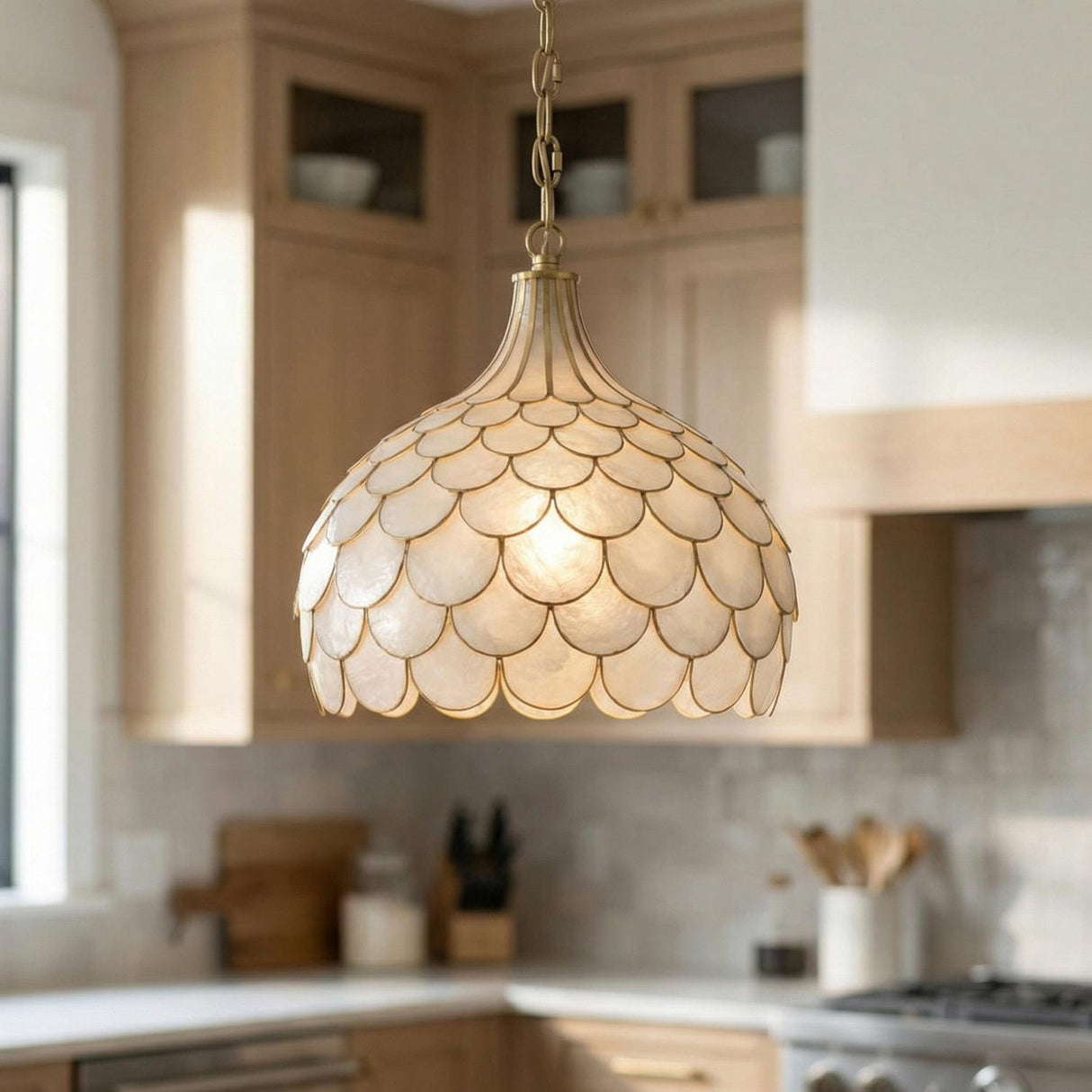 Valentina Medium Pendant 14", Soft Brass and Capiz Shell scalloped Pendant in a Transitional Kitchen with light wood cabinets.