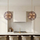 Layla Medium Pendant 18", Smoke Glass Brass leaf design Pendant in a Contemporary Kitchen with a white marble island and brass faucet.