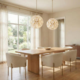 Layla Medium Pendant, Gold white floral globe pendant in a Transitional Dining Room with a light oak table and boucle chairs.