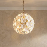 Layla Medium Pendant 18", White Glass Gold scalloped Pendant in a Mediterranean Living Room with a textured limewash wall.