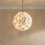 Layla Medium Pendant 18", White Glass Gold scalloped Pendant in a Mediterranean Living Room with a textured limewash wall.